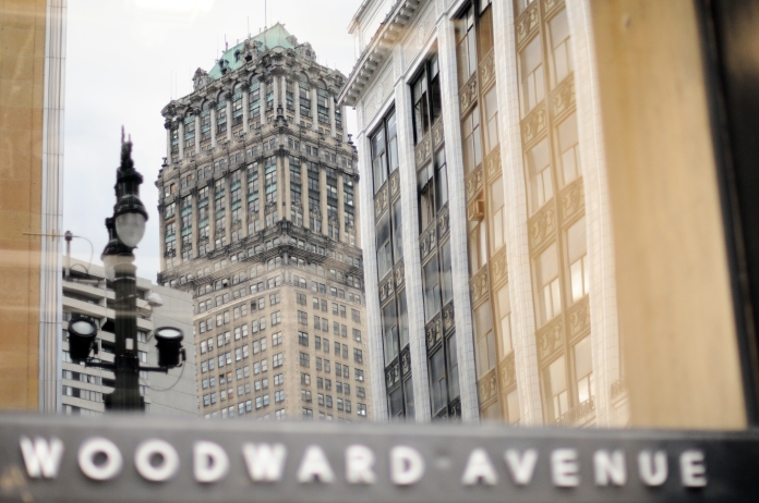 The abandon Neoclassical Book Tower built in 1926 is reflected in a building's glass on the Historic Woodward Avenue