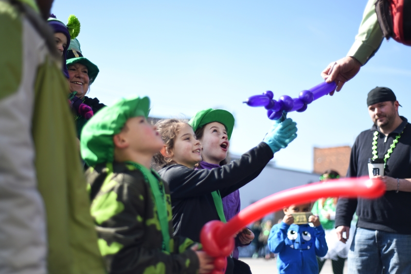 (right) Sophia Harman, 8, May Harman, 7, and Dillan Laible, 6, watch their balloon animals being made. on Michigan Ave. before the parade. Thousands attended the 2015 St. Patrick's Parade in Detroit's historic Irish Corktown neighborhood on a sunny Sunday afternoon March 15, 2015. (Tanya Moutzalias | MLive Detroit)