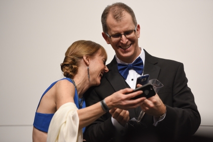 Alison and Tom Bazil, of Bloomfield Hills, laugh over photo they took at the BMW display at the auto show's Charity Preview Friday evening, Jan. 15, 2016. Over 13,000Êattended the 2016 North American International Auto Show's 40th annual Charity Preview at Cobo Center in Detroit. Attendees, dressed in their very best for the black-tie event known as 'Auto Show Prom,' mingled on the showroom floor getting a look at the more than 750 vehicles before Saturday's public opening. (Tanya Moutzalias | MLive Detroit)